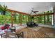 Sunroom with wood floors, lots of windows, black furniture, and hanging plants at 8501 Flanagan Ct, Huntersville, NC 28078