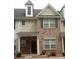 Charming townhome featuring brick and neutral siding, complemented by neatly trimmed windows at 8641 Wandering Creek Way, Charlotte, NC 28227