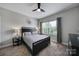 Serene bedroom with a neutral color scheme, dark furniture, soft lighting and window views at 8702 Aspinwall Dr, Charlotte, NC 28216