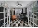 Bright home office with unique patterned floor, built-in shelving, and ample workspace at 8702 Aspinwall Dr, Charlotte, NC 28216