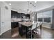 Contemporary kitchen with sleek black cabinets, granite countertops, and a central island at 8702 Aspinwall Dr, Charlotte, NC 28216