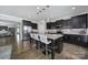 Modern kitchen featuring dark cabinets, stainless steel appliances, granite countertops and seating at the island at 8702 Aspinwall Dr, Charlotte, NC 28216