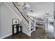 Elegant staircase leading to the upper level, with views of the living area at 8702 Aspinwall Dr, Charlotte, NC 28216