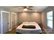 Bedroom featuring two white doors, a window with blinds, and a bed with minimalist decor at 913 Winchester Ave, Monroe, NC 28110