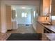 Open kitchen with modern appliances flowing into another room with stylish flooring at 913 Winchester Ave, Monroe, NC 28110