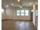 Bright living room featuring recessed lighting, ceiling fan, and large windows allowing natural light at 913 Winchester Ave, Monroe, NC 28110