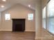 Well-lit living room featuring a decorative fireplace and large windows with blinds at 913 Winchester Ave, Monroe, NC 28110