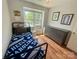 Cozy bedroom with a single bed, large window, and wood-look flooring; a comfortable retreat at 9214 Arbourgate Meadows Ln, Charlotte, NC 28277