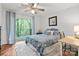 This bedroom has gray walls, light colored floors, and sliding glass doors that look out on the trees at 9214 Arbourgate Meadows Ln, Charlotte, NC 28277