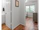 Hallway view with a glimpse of a bathroom and an additional room, connecting various living spaces at 9214 Arbourgate Meadows Ln, Charlotte, NC 28277