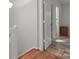 Upstairs hallway featuring hardwood floors and access to rooms, blending style and practicality at 9214 Arbourgate Meadows Ln, Charlotte, NC 28277