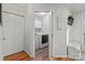 Bright laundry room features modern washer and dryer, white cabinets, and attractive wood-look flooring at 9214 Arbourgate Meadows Ln, Charlotte, NC 28277