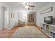 Bright, airy living room with a ceiling fan, TV, bookcase, and large rug; perfect for relaxing at 9214 Arbourgate Meadows Ln, Charlotte, NC 28277