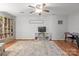 Spacious living room with a ceiling fan, TV, bookcase, and ample natural light; an open design at 9214 Arbourgate Meadows Ln, Charlotte, NC 28277