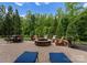 Spacious backyard patio featuring a stone fire pit, outdoor seating, and well-manicured landscaping at 1021 Westbury Dr, Matthews, NC 28104
