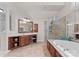 Large primary bath featuring tiled floors, separate vanities, soaking tub and glass shower at 1021 Westbury Dr, Matthews, NC 28104