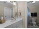 Well-lit bathroom features a large mirror, vanity with sink, and a separate toilet room at 1021 Westbury Dr, Matthews, NC 28104