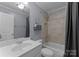 Clean bathroom featuring a shower and bathtub combination with neutral colored tile at 1021 Westbury Dr, Matthews, NC 28104