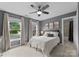 Bright bedroom with a large window, ceiling fan, and ensuite bathroom at 1021 Westbury Dr, Matthews, NC 28104