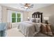Comfortable bedroom showcasing a decorative headboard and neutral color scheme with a large window at 1021 Westbury Dr, Matthews, NC 28104