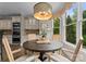 Bright dining area with a round wood table and large window offering green views at 1021 Westbury Dr, Matthews, NC 28104