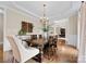 Dining room showcasing hardwood floors, a wooden table, and a decorative chandelier at 1021 Westbury Dr, Matthews, NC 28104