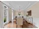 Elegant dining room featuring hardwood floors, chandelier, and wainscoting at 1021 Westbury Dr, Matthews, NC 28104