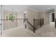Upstairs hallway with natural light, decorative railing and neutral colored carpet at 1021 Westbury Dr, Matthews, NC 28104