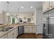 Spacious kitchen showcasing stainless steel appliances, granite countertops, and hardwood flooring at 1021 Westbury Dr, Matthews, NC 28104