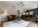 Spacious living room featuring hardwood floors, ceiling fan, and comfortable leather sofas at 1021 Westbury Dr, Matthews, NC 28104