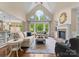 Spacious living room boasting a fireplace, large windows, and hardwood flooring at 1021 Westbury Dr, Matthews, NC 28104
