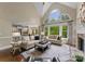 Bright living room featuring a fireplace, large windows, and hardwood flooring at 1021 Westbury Dr, Matthews, NC 28104
