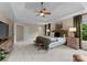 Spacious primary bedroom featuring a tray ceiling, sitting area, and natural light at 1021 Westbury Dr, Matthews, NC 28104