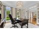 Bright office space featuring a dark wood desk, hardwood floors, and natural light from large windows at 1021 Westbury Dr, Matthews, NC 28104