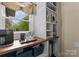 Open pantry with custom shelving, butcher block countertop and natural light at 1021 Westbury Dr, Matthews, NC 28104