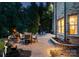 Backyard stone patio with dining area, fire pit, water feature, and exterior view of brick home at 1021 Westbury Dr, Matthews, NC 28104