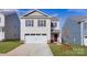 Charming two-story home features a two-car garage and manicured lawn at 1033 20Th Avenue Se Loop, Hickory, NC 28602
