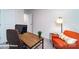 Cozy office space featuring a stylish wooden desk and a comfortable orange chair with natural lighting at 1033 20Th Avenue Se Loop, Hickory, NC 28602
