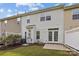 Backyard patio view of a two story home with white siding, and a privacy fence at 104 Clydesdale Ct, Matthews, NC 28104