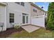 Backyard view from the patio showing a home, privacy fence and landscaping at 104 Clydesdale Ct, Matthews, NC 28104