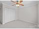 Neutral bedroom offers carpet and a closet with white bi-fold doors at 104 Clydesdale Ct, Matthews, NC 28104