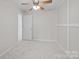 Bedroom with a ceiling fan, a door, and white walls at 104 Clydesdale Ct, Matthews, NC 28104