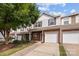 Charming two-story townhome with brick and white siding, featuring a one-car garage and inviting front entrance at 104 Clydesdale Ct, Matthews, NC 28104
