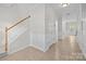 Open foyer showcasing tile floors, staircase with white railings, and wainscoting at 104 Clydesdale Ct, Matthews, NC 28104