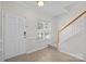 Bright foyer with tile flooring, a staircase, and a window offering natural light at 104 Clydesdale Ct, Matthews, NC 28104