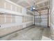Unfinished two-car garage with concrete floor and white walls, equipped with garage door opener at 104 Clydesdale Ct, Matthews, NC 28104