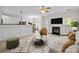 Open-concept living room boasts a fireplace, modern decor, and seamlessly connects to the kitchen at 104 Clydesdale Ct, Matthews, NC 28104