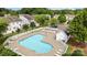 Enjoy the community pool surrounded by lounge chairs and a white picket fence on a sunny day at 104 Clydesdale Ct, Matthews, NC 28104
