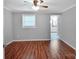 Bright bedroom featuring hardwood floors, fresh paint, and a window allowing natural light at 105 Strickland Ln, Bessemer City, NC 28016