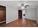 Cozy bedroom featuring hardwood floors, fresh paint, closet, and a ceiling fan at 105 Strickland Ln, Bessemer City, NC 28016